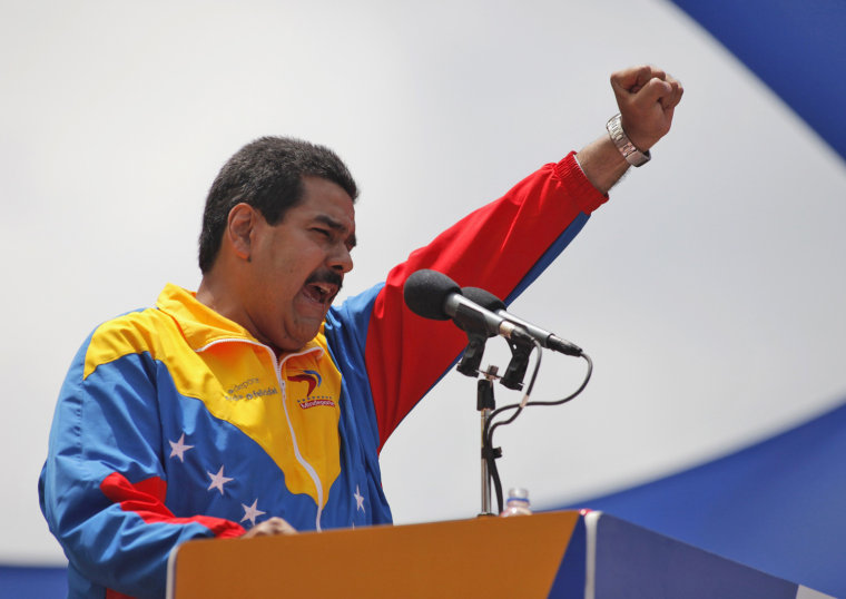 Venezuela's acting President Nicolas Maduro, seen gesturing to supporters Monday, says he will continue Chavez's legacy.