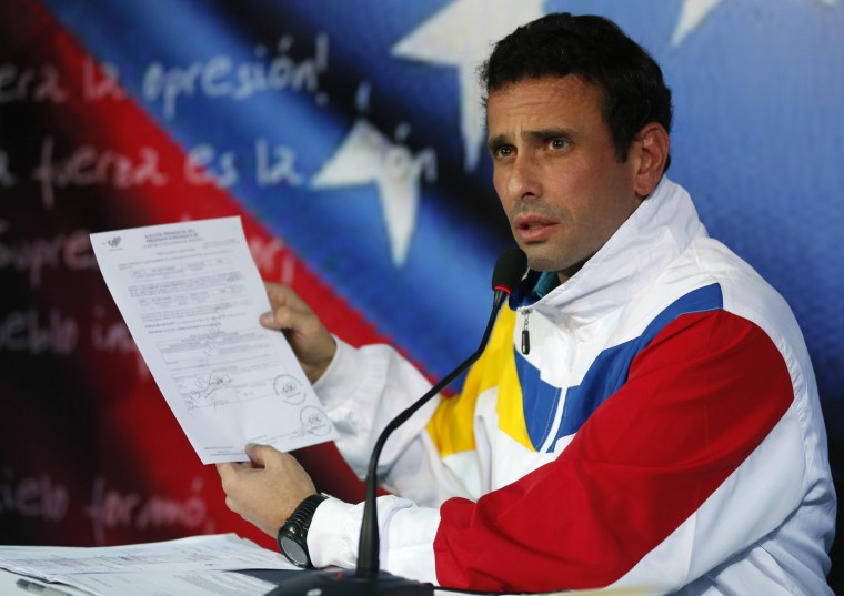 Venezuela's opposition leader and presidential candidate Henrique Capriles, seen showing his election registration papers, accused his opponent of manipulating Chavez's death for electoral gain.