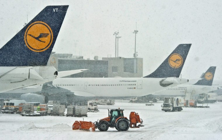 A snowplow removes snow at the airport in Frankfurt, Germany, on March 12, 2013. Over 200 flights were cancelled as bad weather hampered efforts by snow sweepers to clear runways and prevented airline crews from reaching work on time.