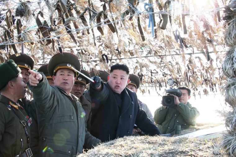 In this March 11, 2013 photo released by the Korean Central News Agency (KCNA) and distributed March 12 by the Korea News Service, North Korean leader Kim Jong Un, third left, looks at South's western border island of Baengnyeong during his visit to the Wolnae Islet Defense Detachment, North Korea. North Korea's young leader urged front-line troops to be on