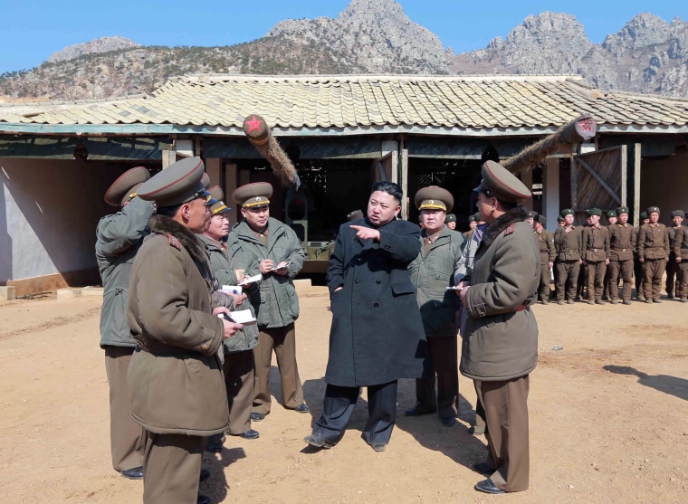 In this March 11, 2013 photo released by the Korean Central News Agency (KCNA) and distributed March 12 by the Korea News Service, North Korean leader Kim Jong Un, center, confers with military officers at a long-range artillery sub-unit of KPA Unit 641 during his visit to front-line military units near the western sea border in North Korea near the South's western border island of Baengnyeong. Kim urged front-line troops to be on