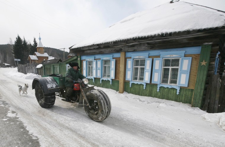 Yushkov drives his self-made three-wheeled cross-country vehicle in the village of Ovsyanka, on March 11, 2013.