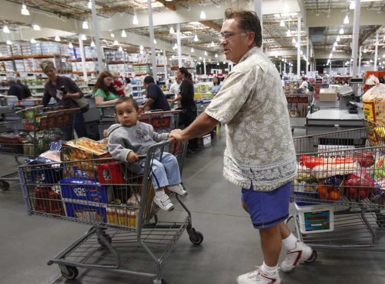 Members line up for registers at a Costco warehouse store in Mountain View, Calif. Purchase records are being used more frequently by public health officials investigating outbreaks of foodborne illness.