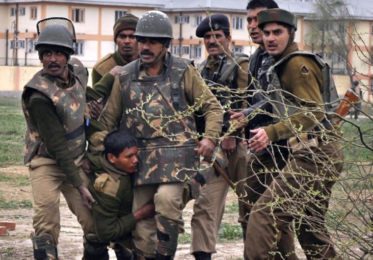 Indian paramilitary soldiers carry a wounded colleague on March 13, 2013.