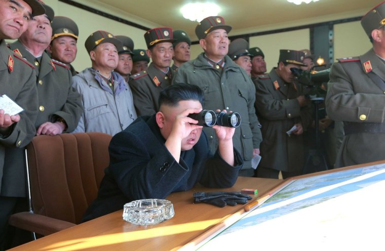 North Korean leader Kim Jong Un and military officers watch a live artillery drill to examine the capabilities of units whose mission is to strike disputed islands on the border with South Korea.