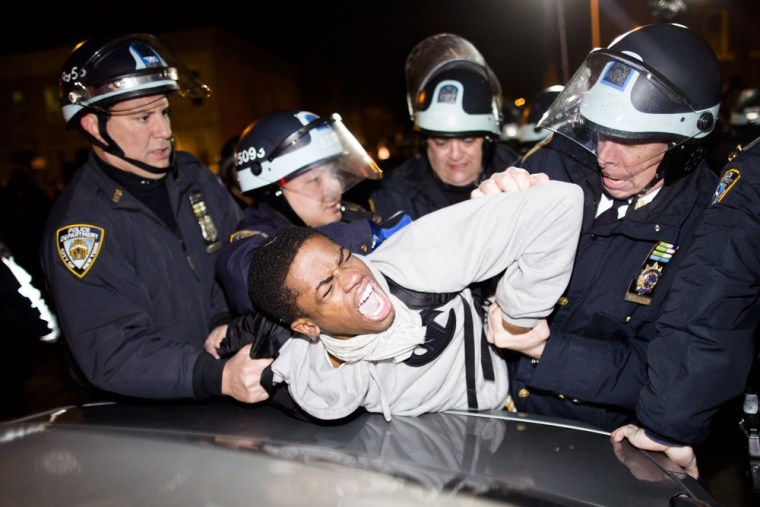 Police officers arrest a demonstrator during a march after a vigil held for Kimani Gray on March 13, 2013.