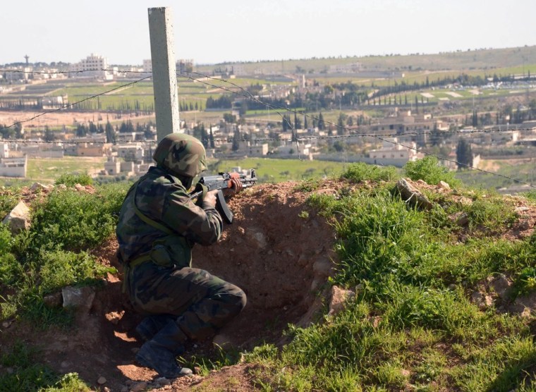 A Syrian government soldier aims his machine gun during an operation in Aleppo on March 6. Rumors that Bashar Assad's government will instate a military draft have caused panic in the war-ravaged country. Editor's note: Image supplied by Syrian state news agency SANA.