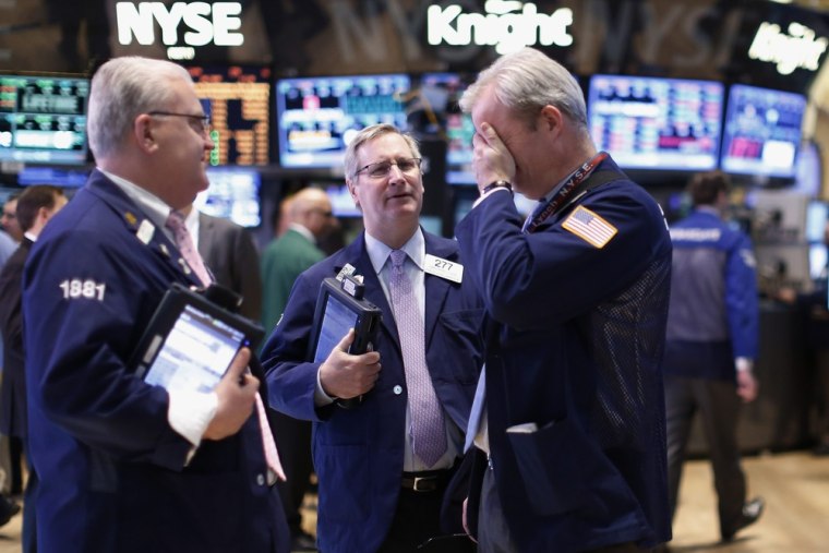 Traders work on the floor at the New York Stock Exchange, March 14, 2013.