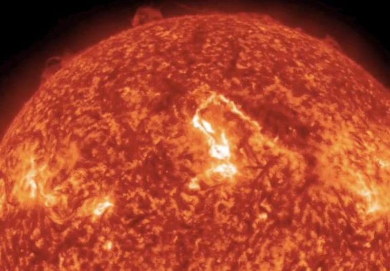 This screenshot from a video taken by NASA's Solar Dynamics Observatory spacecraft shows a coronal mass ejection (center) erupting from the sun on Tuesday.
