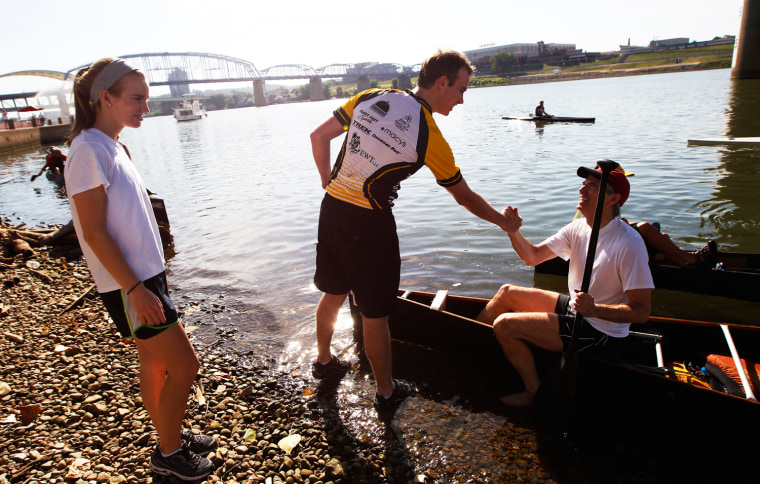 U.S. Sen. Rob Portman is greeted by his daughter Sally, 17, left and son Will, 20 after finishing the annual Cincinnati event, Paddlefest on Saturday, June 23, 2012.