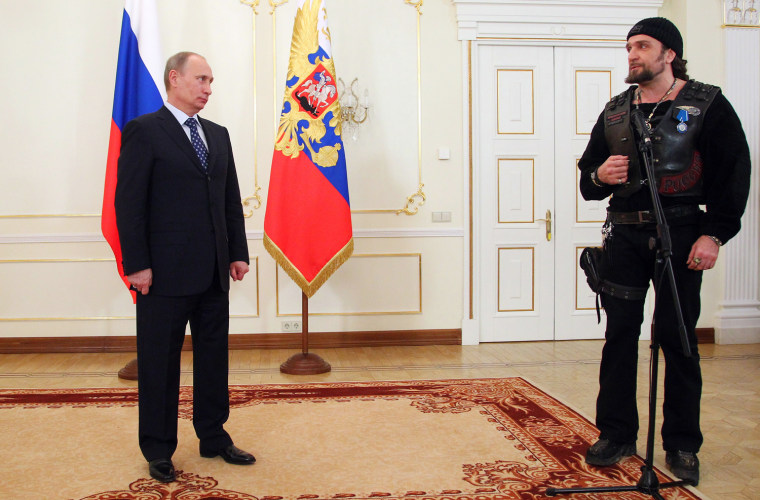 Russia's President Vladimir Putin looks at the leader of Nochniye Volki (the Night Wolves) biker group, Alexander Zaldostanov, also known as Khirurg (the Surgeon), after awarding him at a meeting with members of the Military History Society in the Novo-Ogaryovo residence outside Moscow, on March 14.