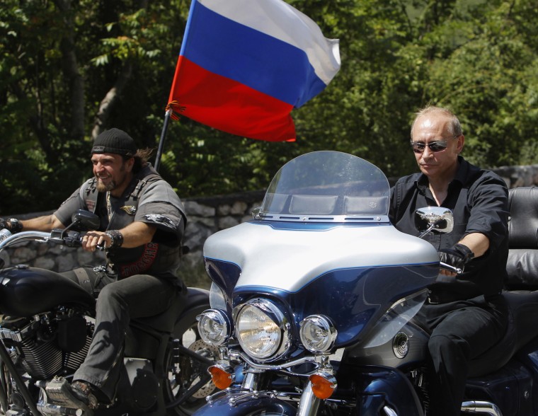 Vladimir Putin, then Russian Prime Minister, rides a Harley Davidson Lehman Trike together with the leader of Nochniye Volki (the Night Wolves) biker group, Alexander Zaldostanov, also known as Khirurg (the Surgeon), during Putin's visit to Russian and Ukrainian motorbikers at their camp near Sevastopol in Ukraine's Crimea, on July 24, 2009.