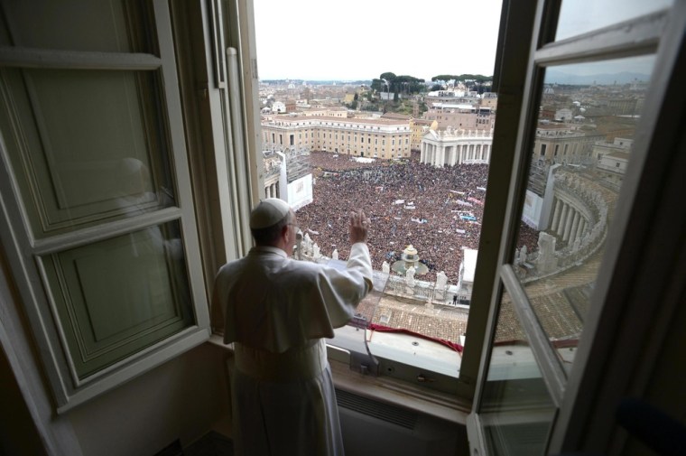 Pope Francis waves to the crowd at St. Peter's Square during his first Angelus prayer at the Vatican on March 17.