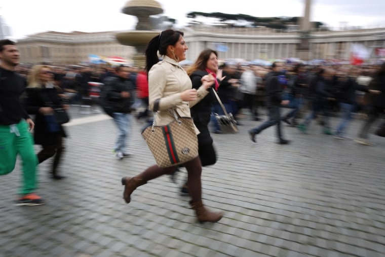 Women rush into St. Peter's Square to see Pope Francis give his first Angelus blessing on March 17 in Vatican City.