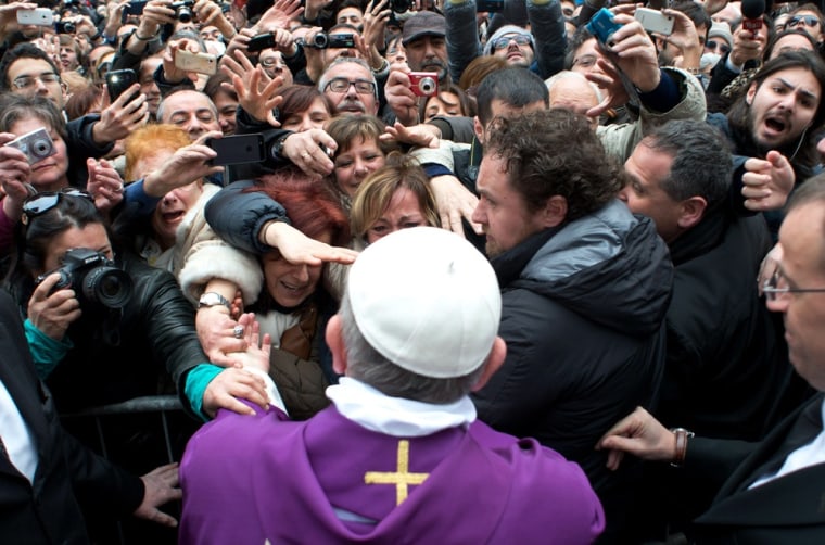 Pope Francis greets the crowds after conducting a mass in the Saint Anna Church inside the Vatican on March 17.