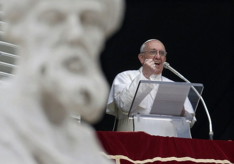 Newly elected Pope Francis appears at the window of his future private apartment to bless the faithful gathered below in St. Peter's Square during the Sunday Angelus prayer at the Vatican.