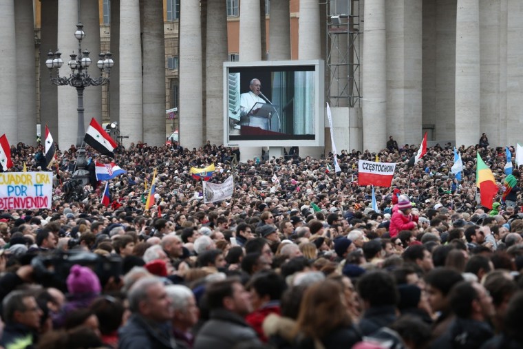 Crowds fill St. Peter's Square as live footage of Pope Francis is projected on a giant screen on March 17.