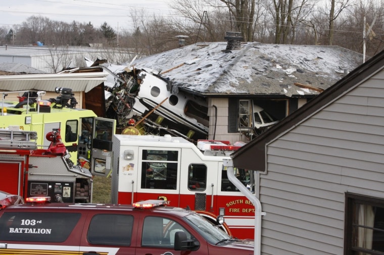 The front end of a Hawker Beachcraft Premier jet sits in a room of a home on Iowa Street in South Bend, Ind., Sunday, March 17, 2013. Authorities say a private jet apparently experiencing mechanical trouble crashed resulting in injuries. Federal Aviation Administration spokesman Roland Herwig says the Beechcraft Premier I twin-jet had left Tulsa, Okla.'s Riverside Airport and crashed near the South Bend Regional Airport on Sunday afternoon.