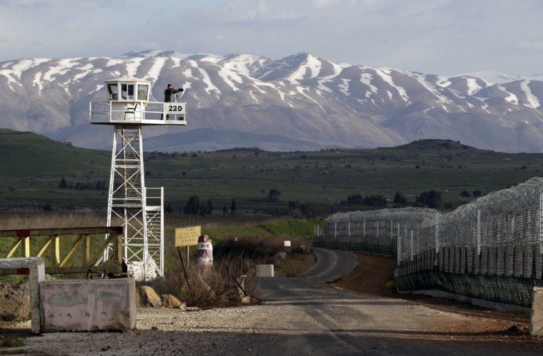 A United Nations peacekeeper stands on an observation tower at the Kuneitra border crossing between Israel and Syria in the Israeli-occupied Golan Heights on March 8.