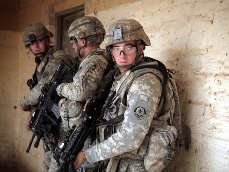 In this July 9, 2008 file photo, U.S. Army soldiers from Charlie Battery, Fires Squadron, Second Stryker Cavalry Regiment prepare to search a classroom as they occupy a school during Operation Fires Festung in Qubah, north of Baghdad in Iraq's volatile Diyala province.