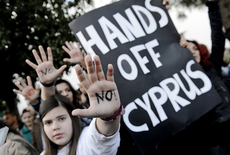 Protesters rally against an EU bailout deal in front of the Cyprus parliament in Nicosia on March 18.