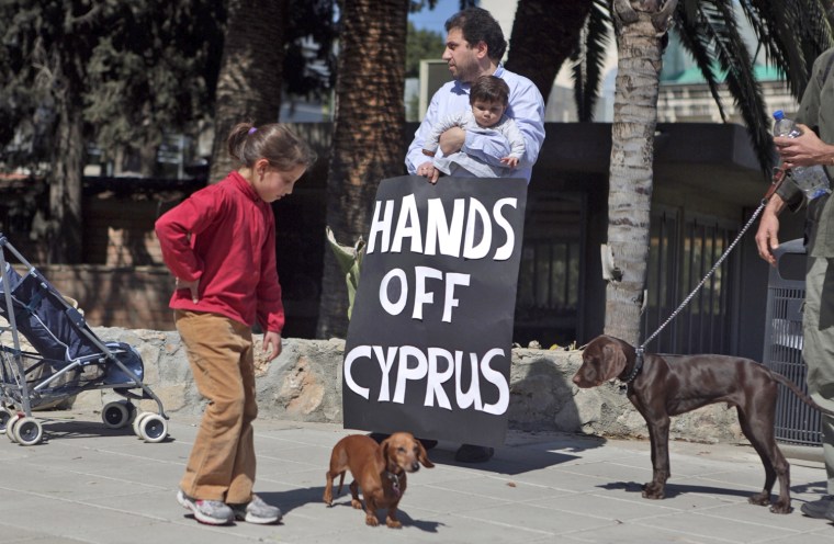 Cypriots protest outside the parliament building in Nicosia, on March 18, 2013.