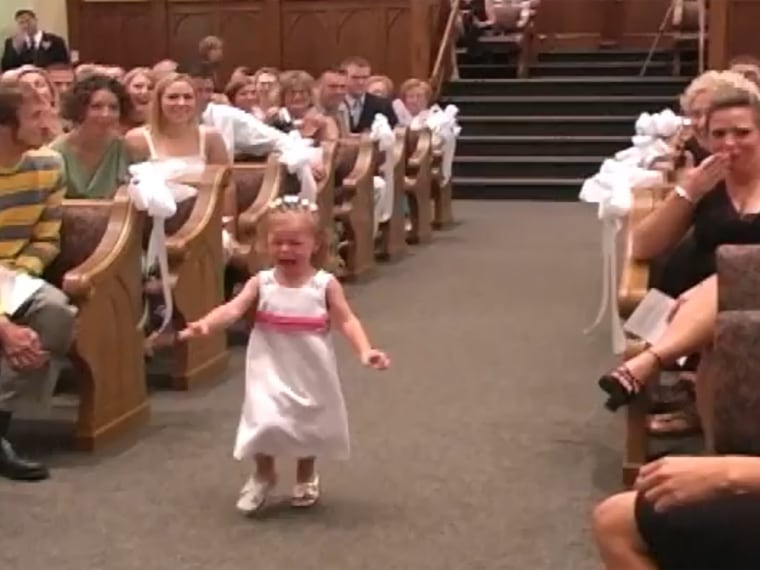 Not having much fun: One little flower girl was showing crying down the aisle in a new YouTube video.