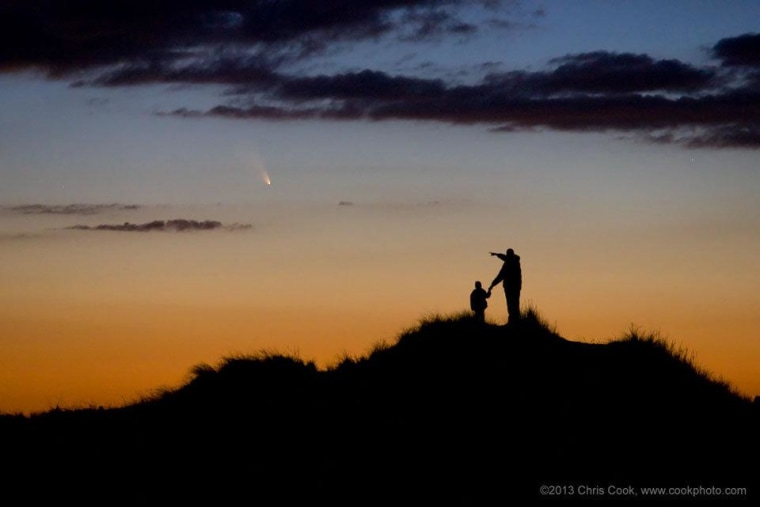 Photographer Chris Cook and his son watch Comet PanSTARRS from First Encounter Beach in Eastham, Mass., on the evening of March 13. The photograph was taken via remote shutter release, using a Canon 5D and a Canon EF 70-200mm f/2.8 L lens. The image served as NASA's Astronomy Picture of the Day for Monday. Even though PanSTARRS has passed its peak brightness, the comet can still be seen by Northern Hemisphere observers after sunset in the western sky.