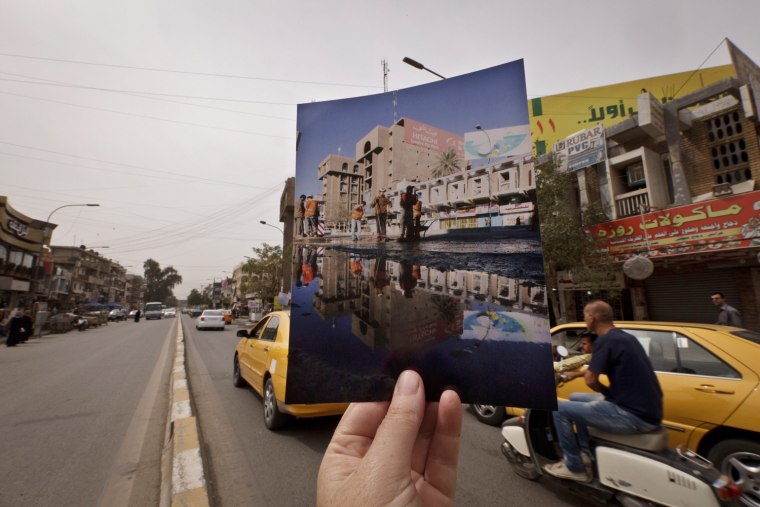 In this Saturday, March 16, 2013, photo, motorists fill the main street in Baghdad's busy shopping district of Karrada at the site of an Associated Press photo taken by Hadi Mizban on Friday, March 7, 2008, after a bombing that killed 53 people and wounded 130. Bloody attacks launched by terrorists who thrived in the post-invasion chaos are painfully still frequent, albeit less so than a few years back, and sectarian and ethnic rivalries are again tearing at the fabric of national unity.