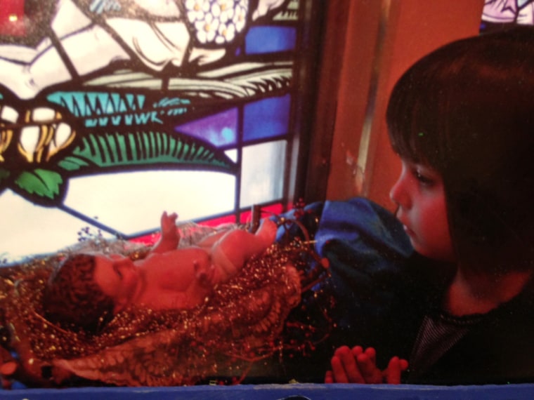 Paloma Duffy, 4, prays to the baby Jesus.