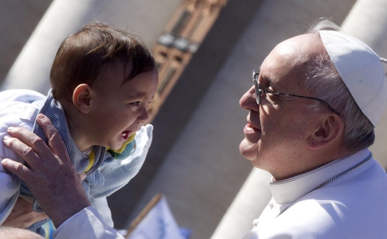 Pope Francis blesses a child as he arrives in St. Peter's square for his inauguration mass, Vatican City, on March 19. Thousands of faithful, as well as political and religious dignitaries from all over the world, were expected to attend the inauguration mass of Pope Francis.