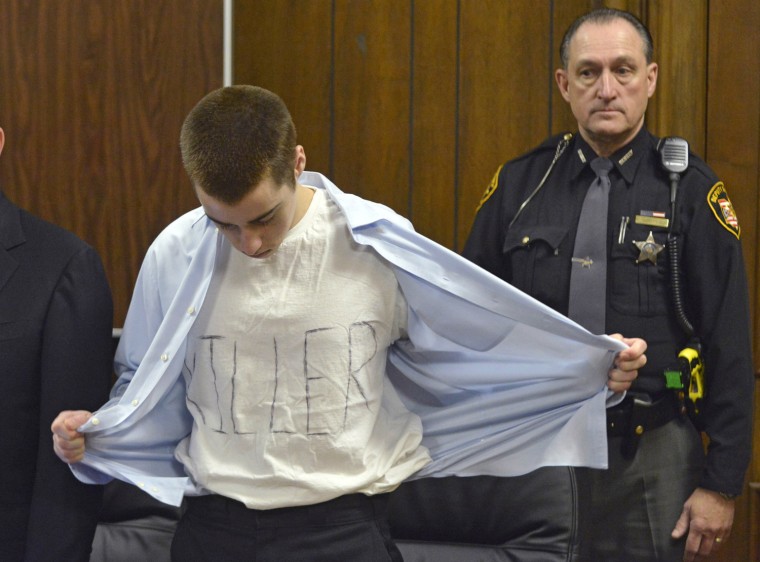 T.J. Lane unbuttons his shirt during sentencing Tuesday in Chardon, Ohio.