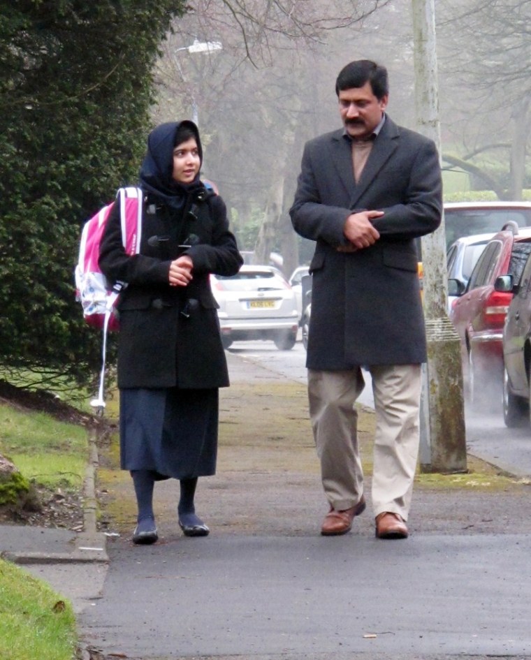 Malala Yousafzai, the Pakistani schoolgirl shot in the head by the Taliban, with her father Ziauddin, as she attends her first day of school.