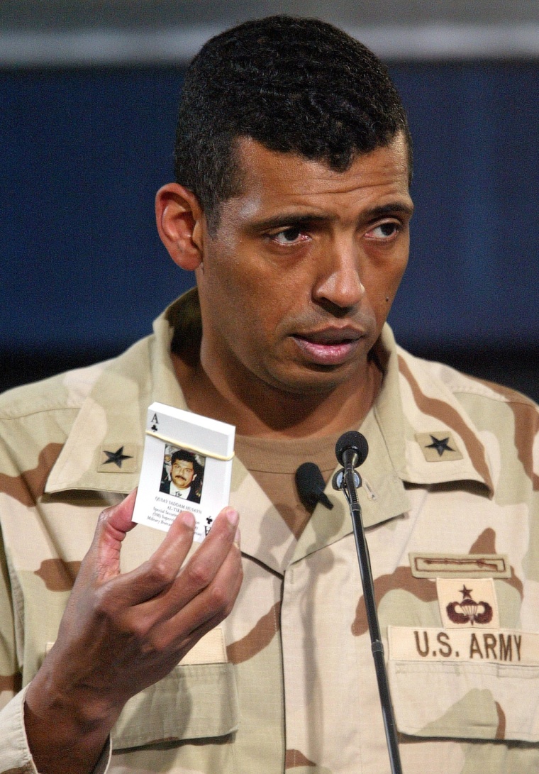 U.S. Brigadier General Vincent Brooks holds up a pack of playing cards with pictures on each of Iraqi's wanted by the U.S. on April 11, 2003. The deck will be issued to coalition troops to help them remember the faces of personalities they can