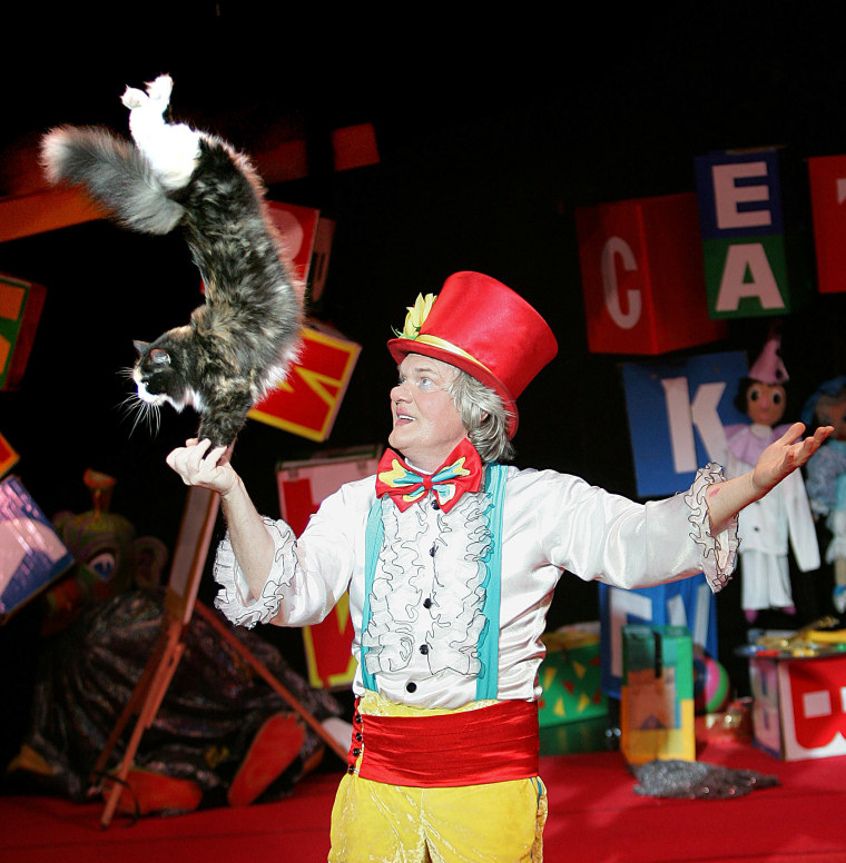 A cat performs a trick with Yuri Kuklachev during a performance of the Moscow Cats Theatre in New York.