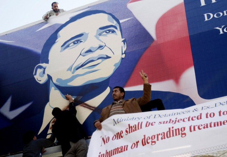 Palestinian activists vandalize a poster of U.S. President Barack Obama in the West Bank city of Bethlehem on Monday.