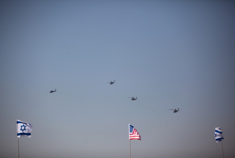 U.S. Army helicopters escort President Barack Obama's Marine One helicopter (not seen), as it departs from Ben Gurion Airport on March 20, near Tel Aviv.