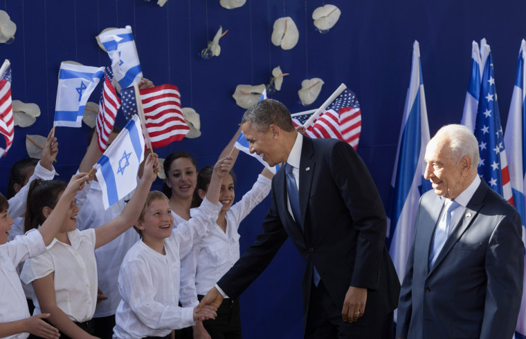 President Barack Obama, center, shakes hands with Israeli children as he is welcomed by Israeli President Shimon Peres, right, in Jerusalem, on March 20.