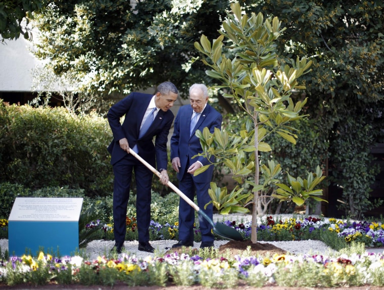 President Barack Obama and Israel's President Shimon Peres plant a magnolia tree from the White House, at Peres' residence in Jerusalem, on March 20.
