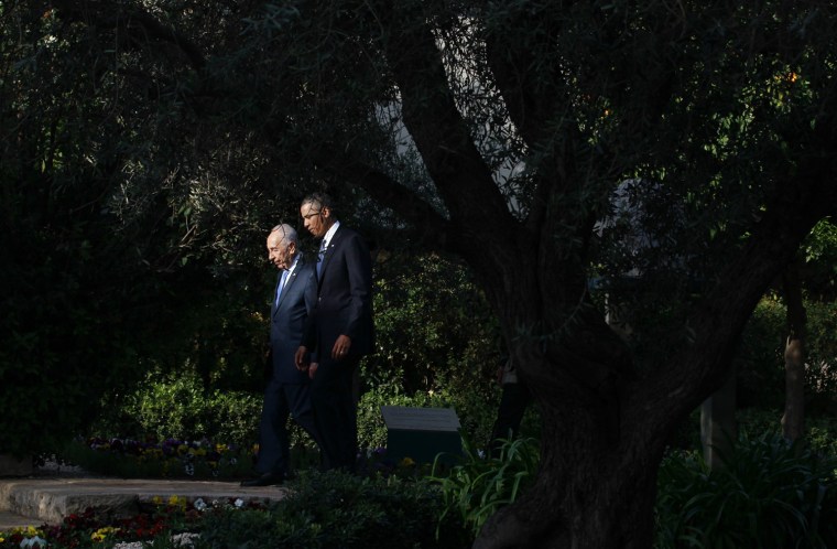 President Barack Obama walks in the garden of Israel's President Shimon Peres, left, in Jerusalem on March 20.
