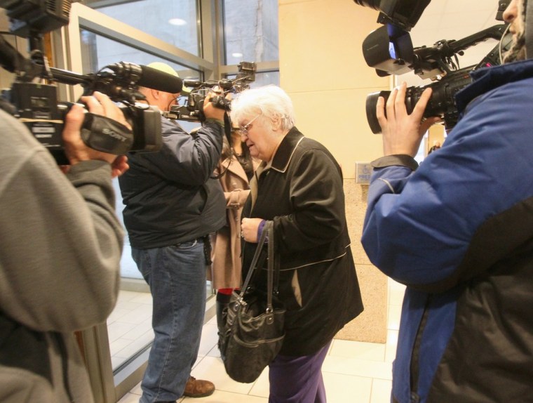 Carol Beasley, mother of convicted murderer Richard Beasley, leaves the Summit County Courthouse on Tuesday, March 12, 2013, in Akron, Ohio. Richard Beasley was found guilty with aggravated murder in the killing two men from Ohio and one from Norfolk, Va. by luring them with Craigslist job offers.