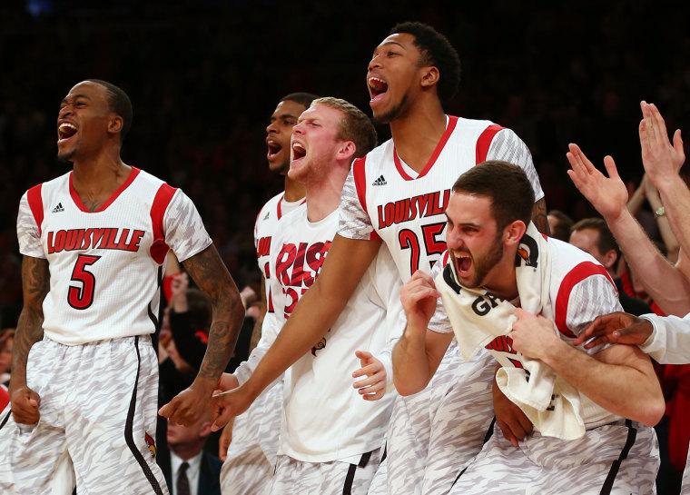 NEW YORK, NY - MARCH 16: Louisville Cardinals players celebrate on the bench against the Syracuse Orange during the final of the Big East Men's Baske...