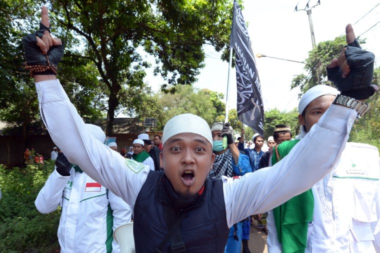 A Muslim man gestures during a protest against the Taman Sari Batak Christian Protestant Church on March 21, 2013. Around 100 Christians held a counter rally to demand the government halt the demolition of their church.