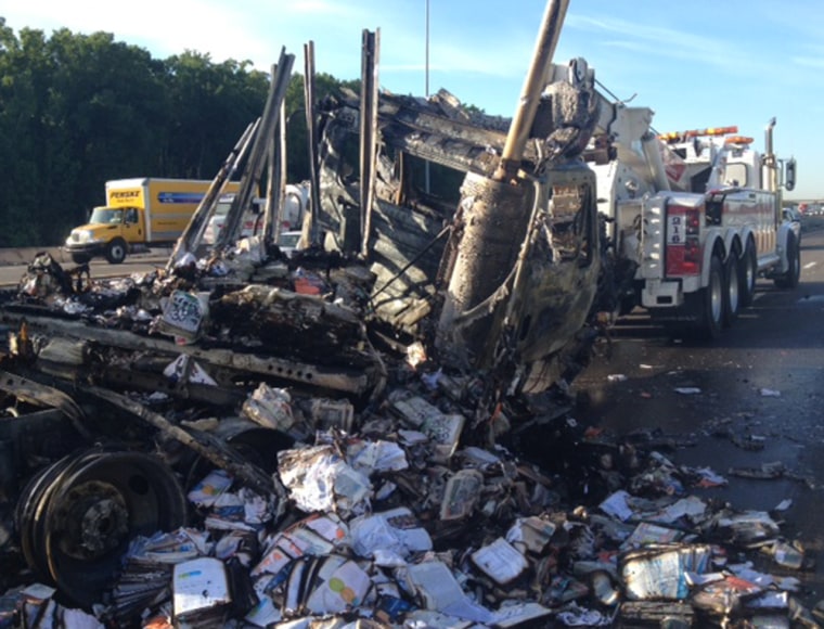 Damaged and destroyed mail is seen among the wreckage of the fiery crash along Interstate 75.