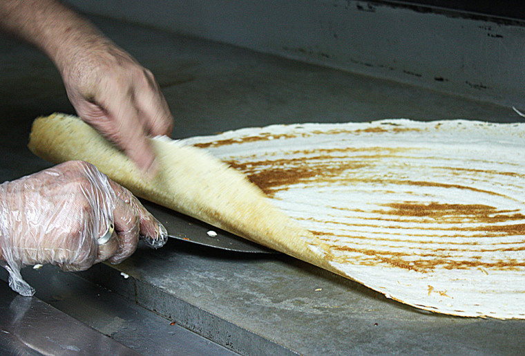 Flip the dosa when it starts turning golden brown.