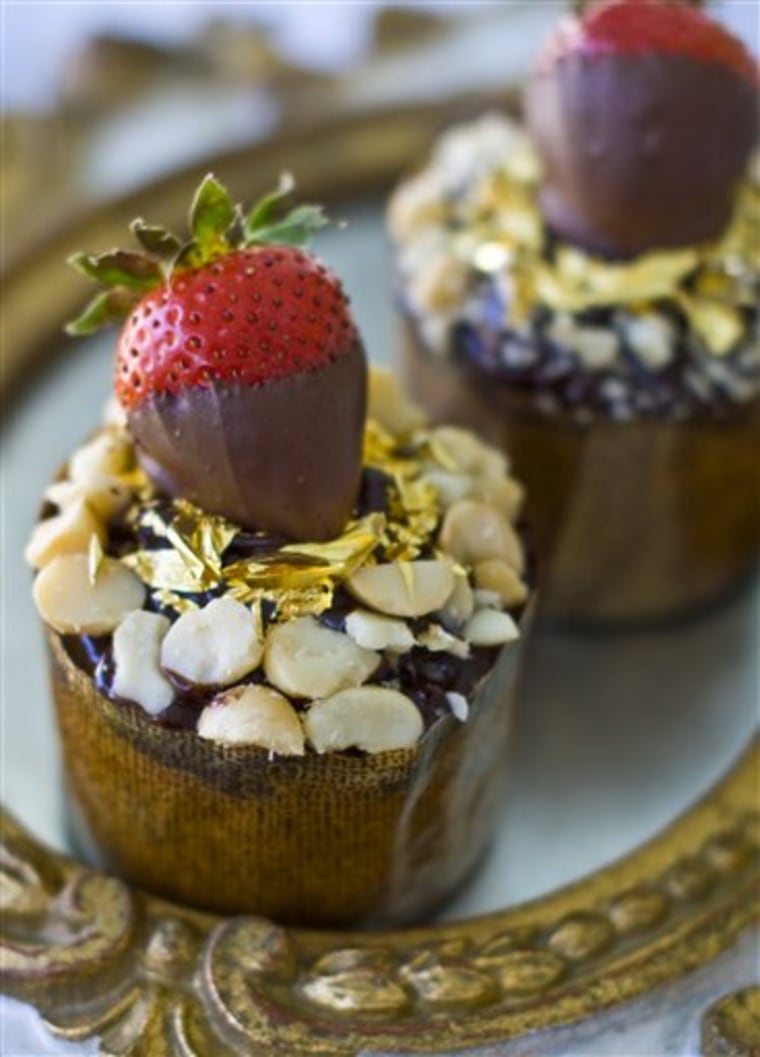 This Monday, Sept. 26, 2011 photo shows $16 muffins in Concord, N.H. Before serving these muffins, sprinkle the macadamia nuts around the outer edge, then sprinkle the gold leaf over the center surface. Top each with a chocolate-covered strawberry.