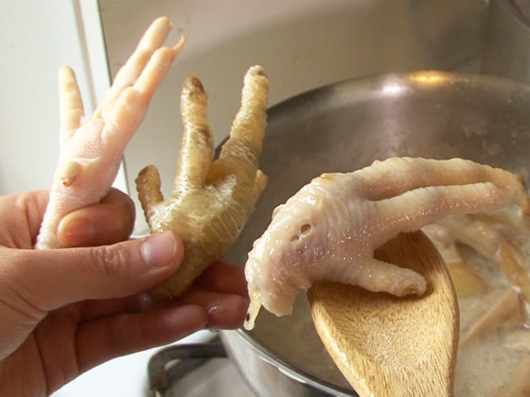 Chichi Wang preps chicken feet for cooking. She likens the chewiness of the feet to gummy bears.