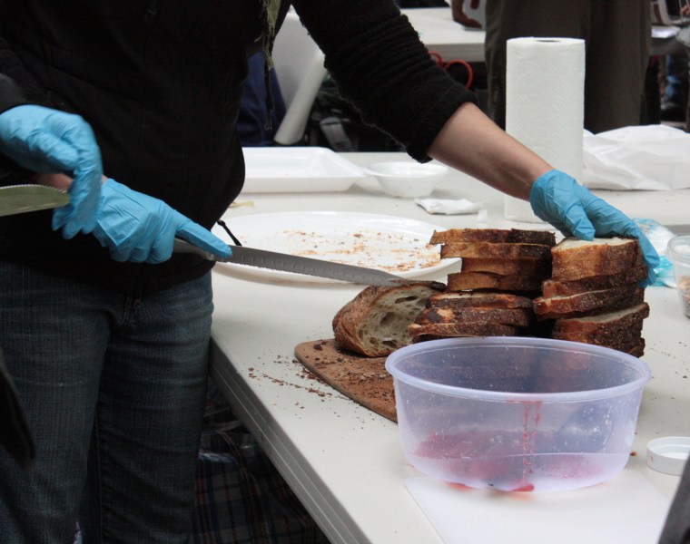 Volunteers break bread for Occupy Wall Street protesters.