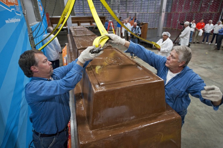 Garry Hine, left, and Gary Wychocki help move a giant chocolate bar to a scale Tuesday, Sept. 13, in Chicago. The chocolate bar weighs 12,000 pounds and measures 3-feet high and 21-feet long. It includes 1,200 pounds of almonds, 5,500 pounds of sugar, 2,000 pounds of milk powder, 1,700 pounds of cocoa butter and 1,400 pounds of chocolate liquor. The bar will tour schools across the United States as part of a portion-control education campaign called