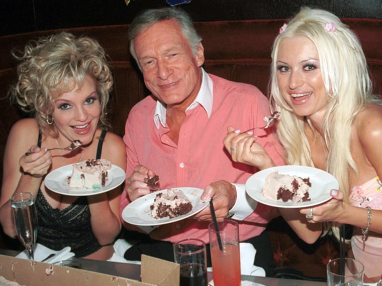 BEVERLY HILLS, CA - SEPTEMBER 25: Playboy models Bridget Marquardt, left, and Izabella Kasprzyk eat cake with Hugh Hefner.